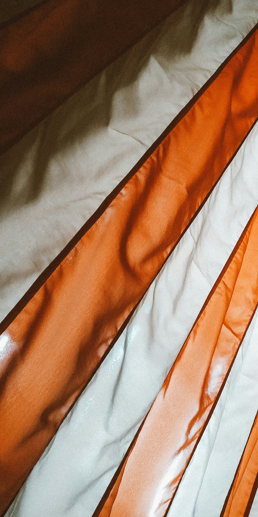 orange and white stripe textile