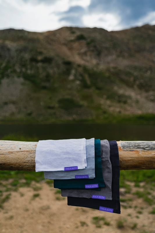 a bunch of towels hanging from a wooden pole