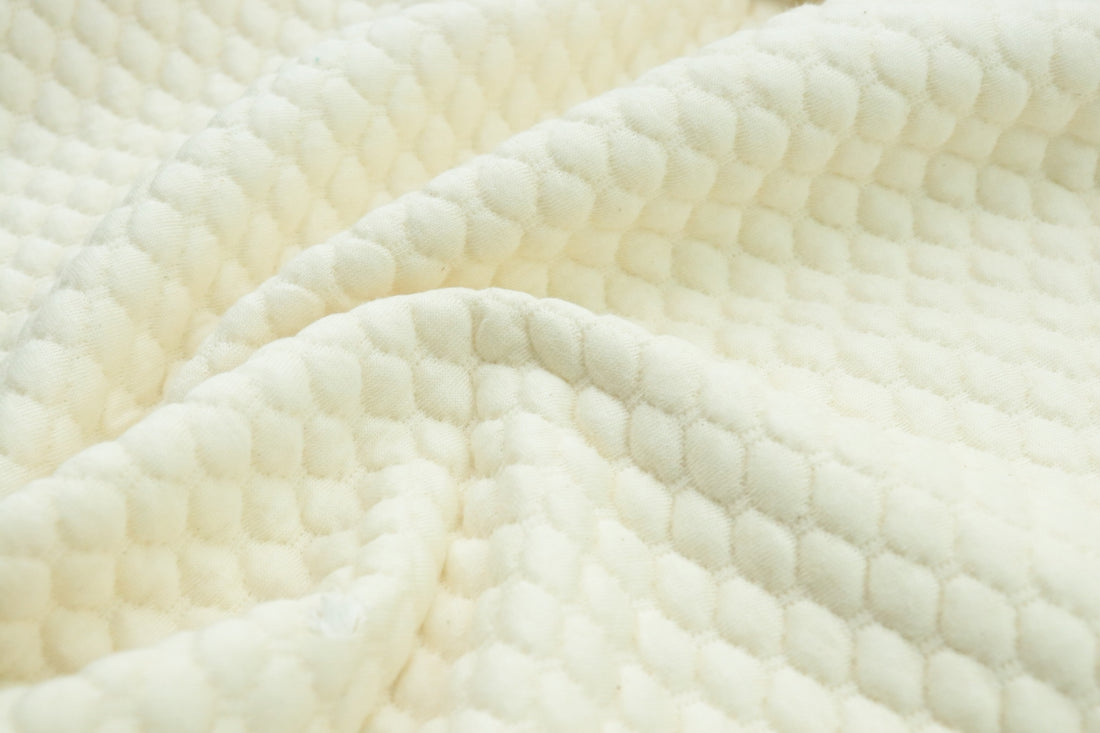a close up view of a white blanket
