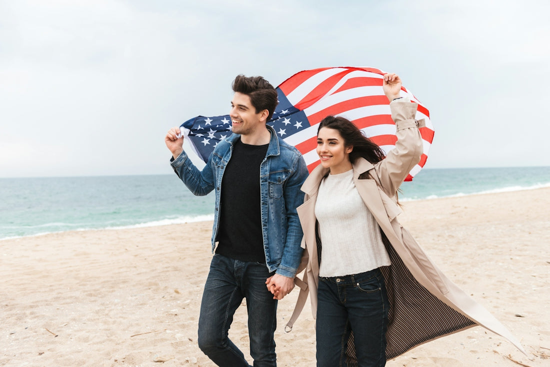 a man and a woman holding an american flag