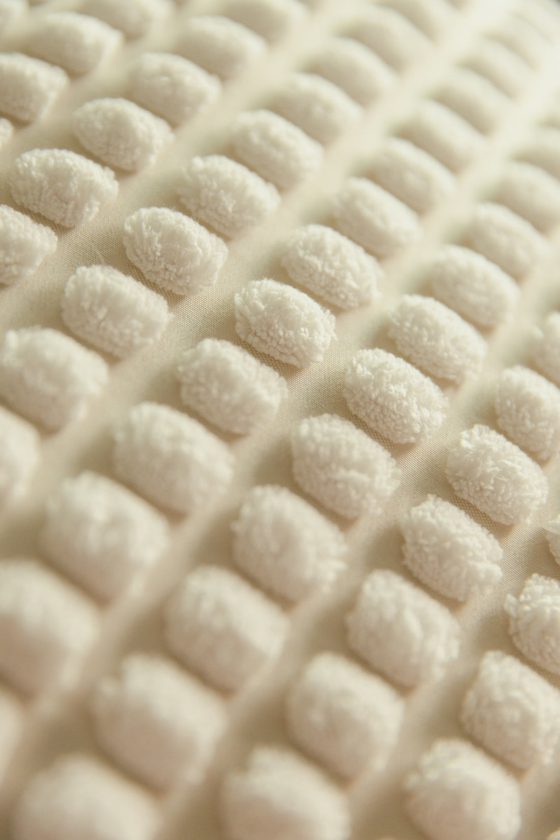Close-up of a textured, white fabric.