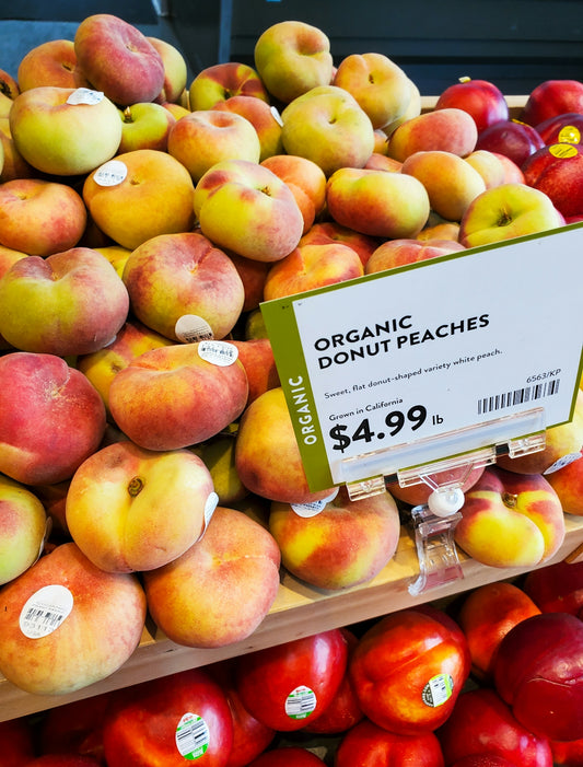 Fresh organic donut peaches displayed for sale