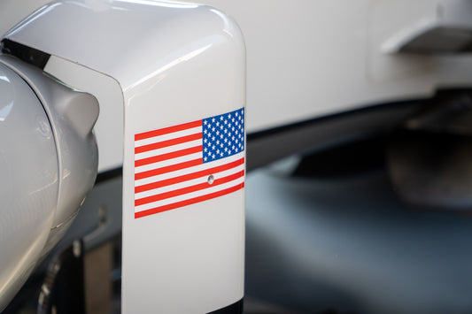 An american flag sticker is on a white surface.