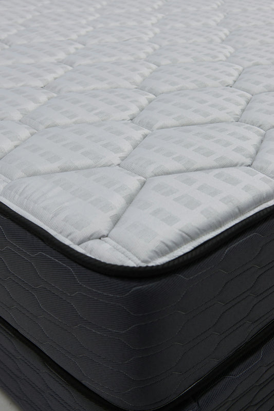 Close-up of a quilted mattress with dark sides.