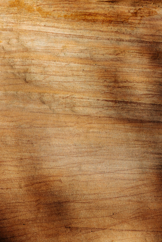 Close-up of a light brown wooden surface with grain.