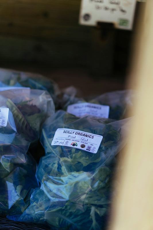 Bags of scilly organics leafy greens for sale.